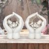 Set of Two Small Shelter 7cm Baby in Cradled Hands Figurines